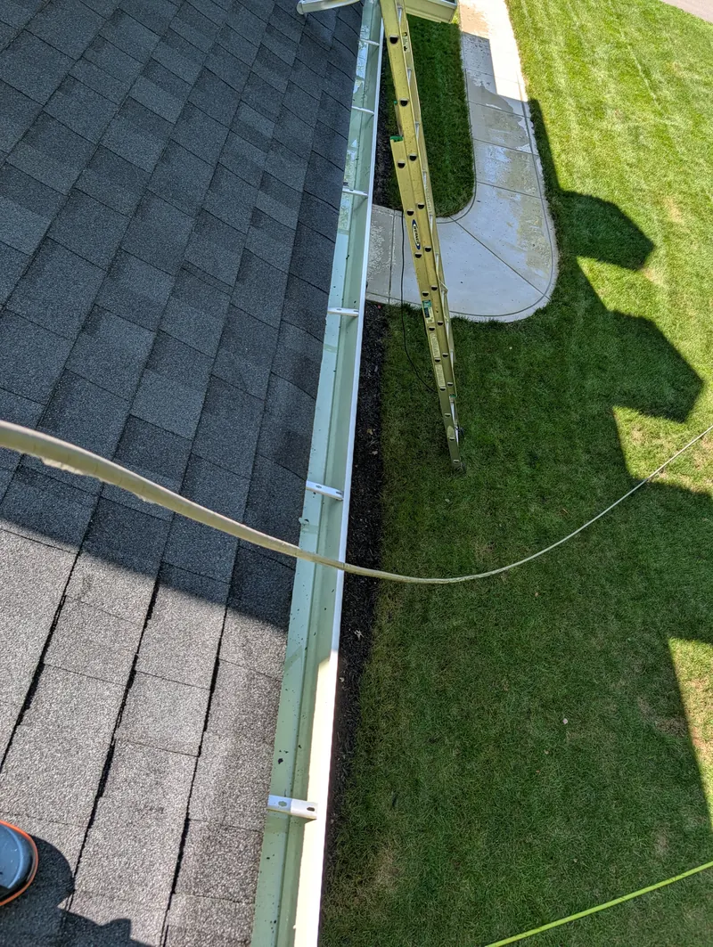 Cleared gutter along a shingle roof in Branford