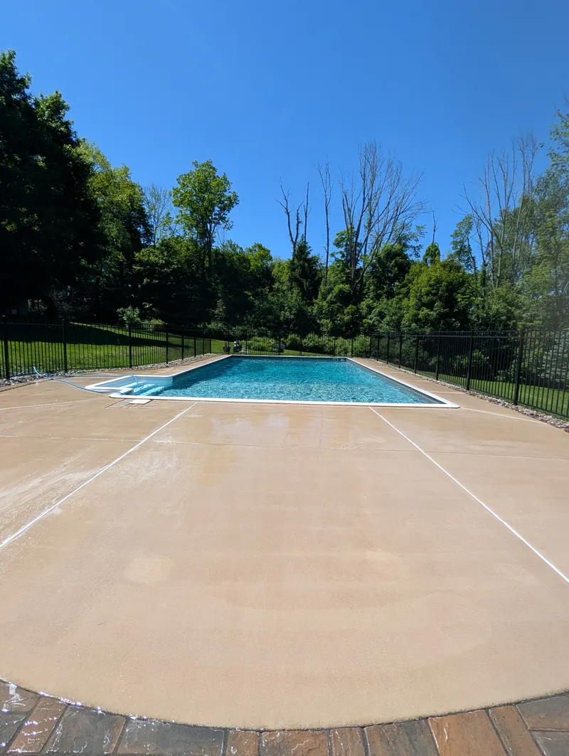 Clean concrete pool deck in Branford